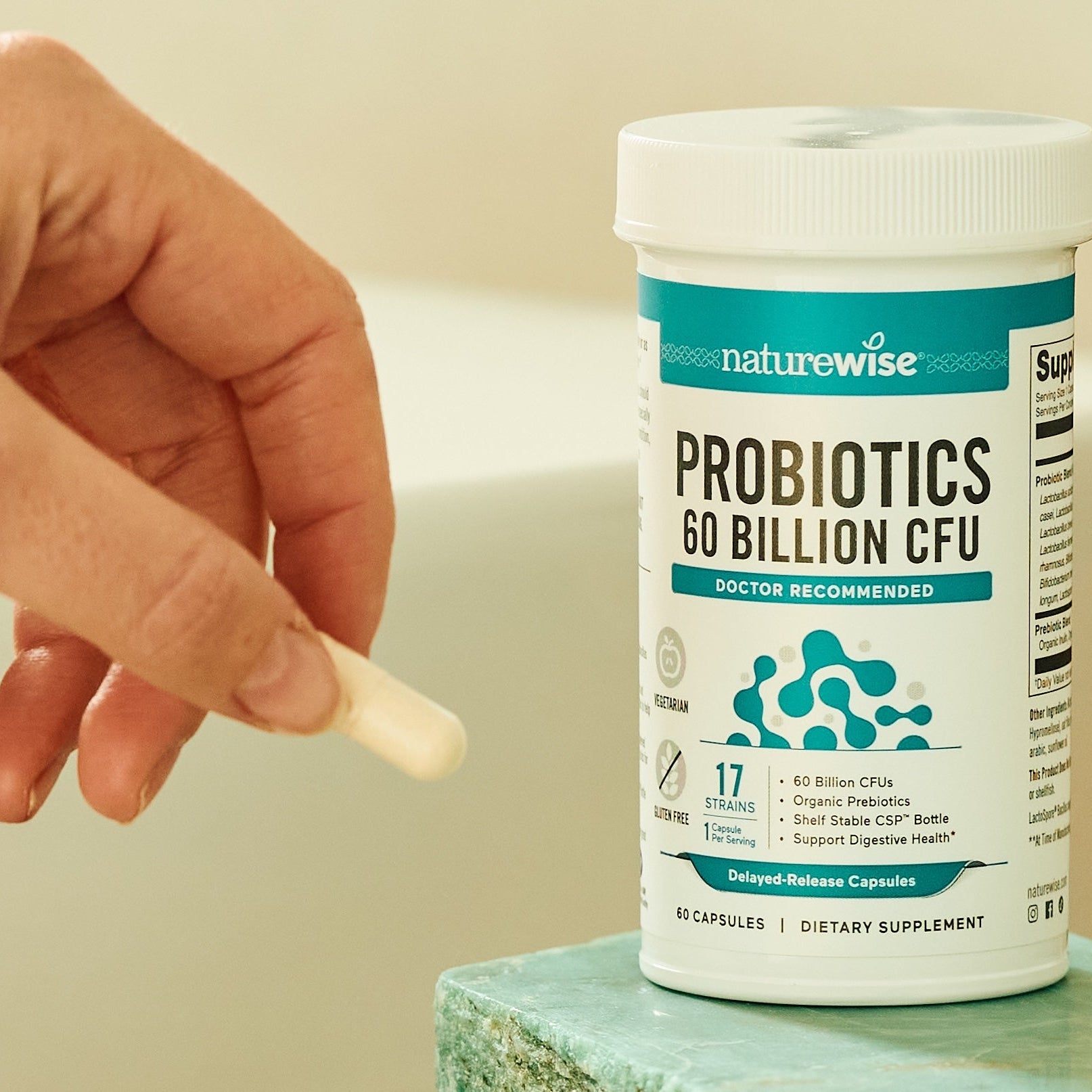 hand taking probiotics